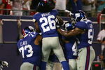 EAST RUTHERFORD, NJ - AUGUST 17: Jeremy Clark #73, DeAndre Wright #26, and Jonathan Goff #54 of the New York Giants celebrate with teammate Tommie Hill #63 after his interception, returned for a game-winning touchdown against Carolina Panthers during a preseason NFL game on August 17, 2009 at Giants Stadium in East Rutherford, New Jersey. (Photo by Jared Wickerham/Getty Images)