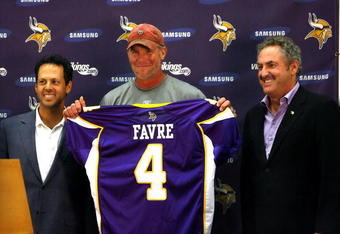 EDEN PRAIRIE, MN - AUGUST 18: Brett Favre (C), Mark Wilf (L) and Zygi Wilf show the media Favre's Minnesota Vikings jersey on August 18, 2009 at Winter Park in Eden Prairie, Minnesota. (Photo by Scott A. Schneider/Getty Images)