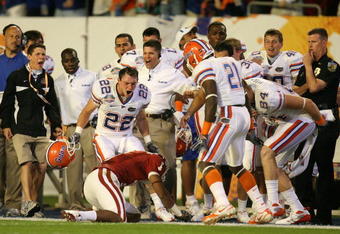 MIAMI - JANUARY 08:  Cade Holliday #22 and Major Wright #21 of the Florida Gators taunt Manuel Johnson #1 of the Oklahoma Sooners after Johnson couldn't hold on to the ball after taking a hard hit from Wright on the sideline during the FedEx BCS National Championship game at Dolphin Stadium on January 8, 2009 in Miami, Florida. Florida won 24-14. (Photo by Doug Benc/Getty Images)