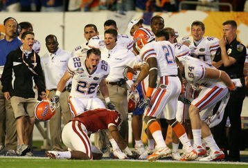 MIAMI - JANUARY 08:  Cade Holliday #22 and Major Wright #21 of the Florida Gators taunt Manuel Johnson #1 of the Oklahoma Sooners after Johnson couldn't hold on to the ball after taking a hard hit from Wright on the sideline during the FedEx BCS National Championship game at Dolphin Stadium on January 8, 2009 in Miami, Florida. Florida won 24-14. (Photo by Doug Benc/Getty Images)