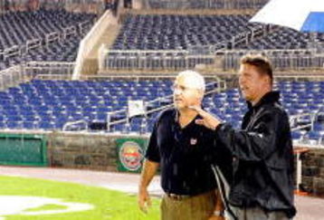 WASHINGTON - JUNE 03:  Assistant General Manager Mike Rizzo of the Washington Nationals talks with Jeff Kellogg and the umpire crew during a rain delay of the game between the San Francisco Giants and the Washington Nationals at Nationals Park on June 3, 2009 in Washington, DC.  (Photo by Greg Fiume/Getty Images)