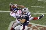 GLENDALE, AZ - FEBRUARY 03:  David Tyree #85 of the New York Giants catches a 32-yard pass from Eli Manning #10 as Rodney Harrison #37 of the New England Patriots attempts to knock it out in the fourth quarter of Super Bowl XLII on February 3, 2008 at the University of Phoenix Stadium in Glendale, Arizona. The Giants defeated the Patriots 17-14.  (Photo by Doug Pensinger/Getty Images)