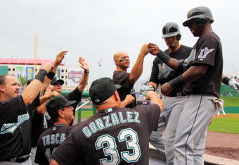 WASHINGTON - AUGUST 6:  Shortstop Hanley Ramirez #2 of the Florida Marlins is congratulated by teammates after scoring a run in the first inning against the Washington Nationals during their MLB game on August 6, 2009 at Nationals Park in Washington, DC.  (Photo by Doug Pensinger/Getty Images)