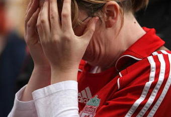LIVERPOOL, ENGLAND - APRIL 15:  A fan reacts as she pays her respects at the Hillsborough memorial at Anfield on April 15, 2009, Liverpool, England.  Thousands of fans, friends and relatives are descending on Liverpool's Anfield Stadium to mark the 20th anniversary of the Hillsborough disaster. A total of 96 Liverpool supporters lost their lives during a crush at an FA Cup semi final against Nottingham Forest at the Hillsborough football ground in Sheffield, South Yorkshire in 1989.  (Photo by Christopher Furlong/Getty Images)