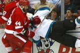 DETROIT - MAY 5:  Johan Franzen #93 and Todd Bertuzzi #44 both of the Detroit Red Wings lay a check on Kyle McLaren #4 of the San Jose Sharks during Game Five of the 2007 NHL Western Conference Semifinals on May 5, 2007 at Joe Louis Arena in Detroit, Michigan.  (Photo by Dave Sandford/Getty Images)