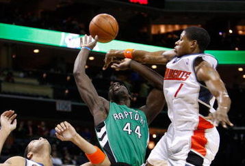 CHARLOTTE, NC - MARCH 16:  Pops Mensah-Bonsu #44 of the Toronto Raptors is caught between Sean May #42 and Cartier Martin #1 of the Charlotte Bobcats at Time Warner Cable Arena on March 16, 2009 in Charlotte, North Carolina.  NOTE TO USER: User expressly acknowledges and agrees that, by downloading and/or using this Photograph, user is consenting to the terms and conditions of the Getty Images License Agreement.  (Photo by Streeter Lecka/Getty Images)