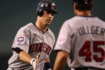 ANAHEIM, CA - JULY 24:   Joe Mauer #7 of the Minnesota Twins is greeted by third base coach Scott Ullger #45 after Mauer hit a home run in the fourth inning against the Los Angeles Angels of Anaheim on July 24, 2009 at Angel Stadium in Anaheim, California.  (Photo by Stephen Dunn/Getty Images)