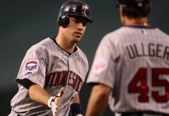 ANAHEIM, CA - JULY 24:   Joe Mauer #7 of the Minnesota Twins is greeted by third base coach Scott Ullger #45 after Mauer hit a home run in the fourth inning against the Los Angeles Angels of Anaheim on July 24, 2009 at Angel Stadium in Anaheim, California.  (Photo by Stephen Dunn/Getty Images)