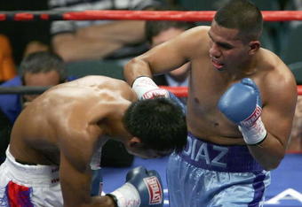 LAS VEGAS - JULY 15:  Juan Diaz (R) hits Randy Suico with a right during the WBA lightweight world championship fight at the MGM Grand Garden Arena July 15, 2006 in Las Vegas, Nevada. Diaz won the fight by TKO in the 9th round to retain his title.  (Photo by Ethan Miller/Getty Images)