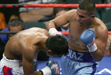 LAS VEGAS - JULY 15:  Juan Diaz (R) hits Randy Suico with a right during the WBA lightweight world championship fight at the MGM Grand Garden Arena July 15, 2006 in Las Vegas, Nevada. Diaz won the fight by TKO in the 9th round to retain his title.  (Photo by Ethan Miller/Getty Images)
