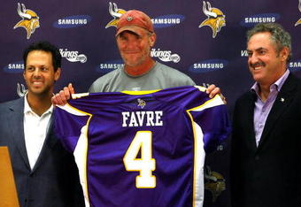 EDEN PRAIRIE, MN - AUGUST 18: Brett Favre (C), Mark Wilf (L) and Zygi Wilf show the media Favre's Minnesota Vikings jersey on August 18, 2009 at Winter Park in Eden Prairie, Minnesota. (Photo by Scott A. Schneider/Getty Images)