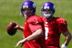 EDEN PRAIRIE, MN - AUGUST 18: Brett Favre #4 (L) throw a pass during a Minnesota Vikings practice session as John David Boty watches on August 18, 2009 at Winter Park in Eden Prairie, Minnesota. Favre has reportedly agreed to play for the Vikings, a reversal of his announced retirement. (Photo by Scott A. Schneider/Getty Images)