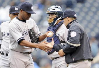 KANSAS CITY, MO - APRIL 12:  Damaso Marte #43 of the New York Yankees is relieved by manager Joe Girardi #27 against the Kansas City Royals on April 12, 2009 at Kauffman Stadium in Kansas City, Missouri. (Photo by G. Newman Lowrance/Getty Images)