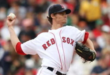 BOSTON - AUGUST 13:  Starting Pitcher Clay Buchholz #61 of the Boston Red Sox delivers the pitch in the first inning during the game against the Detroit Tigersat Fenway Park on August 13, 2009 in Boston, Massachusetts. (Photo by Elsa/Getty Images)