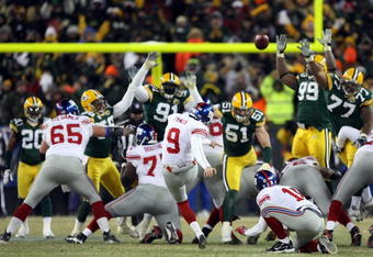 GREEN BAY, WI - JANUARY 20:  Kicker Lawrence Tynes #9 of the New York Giants kicks a game winning 47-yard field goal to win the NFC championship game against the Green Bay Packers on January 20, 2008 at Lambeau Field in Green Bay, Wisconsin.   The Giants defeated the Packers 23-20 in overtime to advance to the Superbowl XLII.  (Photo by Jed Jacobsohn/Getty Images)