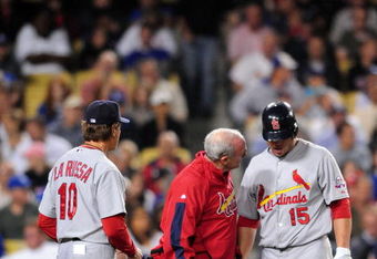 LOS ANGELES, CA - AUGUST 17: Matt Holliday #15 is checked by a trainer and Manager Tony La Russa #10 of the St. Louis Cardinals after Holliday was hit in the leg by a ball in the eighth inning against the Los Angeles Dodgers on August 17, 2009 in Los Angeles, California. The Cardinals defeated the Dodgers 3-2 (Photo by Jacob de Golish/Getty Images)