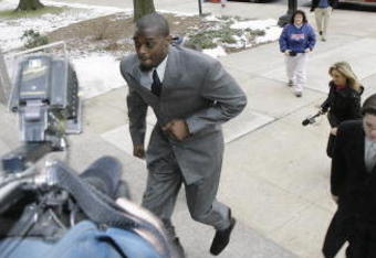 LEBANON - JANUARY 14: New York Giants wide receiver Plaxico Burress runs up the front steps toward members of the media as he arrives at the Lebanon County Courthouse January 14, 2009 in Lebanon, Pa.  Burress is scheduled to appear in a civil trial in a dispute with an automobile dealer over what he owes in damages to a vehicle supplied to him by the dealership. (Photo by Chris Gardner/Getty Images)