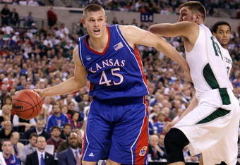 INDIANAPOLIS - MARCH 27:  Cole Aldrich #45 of the Kansas Jayhawks drives against Goran Suton #14 of the Michigan State Spartans during the third round of the NCAA Division I Men's Basketball Tournament at the Lucas Oil Stadium on March 27, 2009 in Indianapolis, Indiana.  (Photo by Andy Lyons/Getty Images)