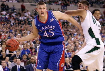INDIANAPOLIS - MARCH 27:  Cole Aldrich #45 of the Kansas Jayhawks drives against Goran Suton #14 of the Michigan State Spartans during the third round of the NCAA Division I Men's Basketball Tournament at the Lucas Oil Stadium on March 27, 2009 in Indianapolis, Indiana.  (Photo by Andy Lyons/Getty Images)