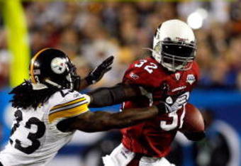 TAMPA, FL - FEBRUARY 01:  Edgerrin James #32 of the Arizona Cardinals runs the ball against Tyrone Carter #23 of the Pittsburgh Steelers during Super Bowl XLIII on February 1, 2009 at Raymond James Stadium in Tampa, Florida. Steelers won 27-23. (Photo by Chris Graythen/Getty Images)