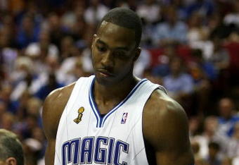 ORLANDO, FL - JUNE 14:  Dwight Howard #12 of the Orlando Magic looks down in the fourth quarter as the Magic trail the Los Angeles Lakers in Game Five of the 2009 NBA Finals on June 14, 2009 at Amway Arena in Orlando, Florida.  NOTE TO USER:  User expressly acknowledges and agrees that, by downloading and or using this photograph, User is consenting to the terms and conditions of the Getty Images License Agreement.  (Photo by Elsa/Getty Images)
