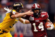 NEW ORLEANS - DECEMBER 21: Jorrick Calvin #14 of the Troy Trojans is tackled by Britt Barefoot #3 of the Southern Mississippi Golden Eagles in the R+L Carriers New Orleans Bowl on December 21, 2008 at the Superdome in New Orleans, Louisiana. The Eagles defeated the Trojans 30-27. (Photo by Chris Graythen/Getty Images)