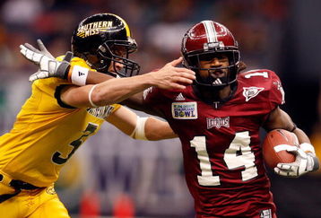 NEW ORLEANS - DECEMBER 21: Jorrick Calvin #14 of the Troy Trojans is tackled by Britt Barefoot #3 of the Southern Mississippi Golden Eagles in the R+L Carriers New Orleans Bowl on December 21, 2008 at the Superdome in New Orleans, Louisiana. The Eagles defeated the Trojans 30-27. (Photo by Chris Graythen/Getty Images)