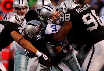 OAKLAND, CA - AUGUST 13:  Quarterback Jon Kitna #3 of the Dallas Cowboys is sacked by Ricky Brown #57 and Jay Richardson #98 of the Oakland Raiders during the preseason game at Oakland-Alameda County Coliseum on August 13, 2009 in Oakland, California. (Photo by Jed Jacobsohn/Getty Images)