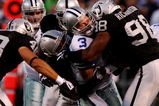 OAKLAND, CA - AUGUST 13:  Quarterback Jon Kitna #3 of the Dallas Cowboys is sacked by Ricky Brown #57 and Jay Richardson #98 of the Oakland Raiders during the preseason game at Oakland-Alameda County Coliseum on August 13, 2009 in Oakland, California. (Photo by Jed Jacobsohn/Getty Images)