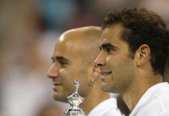 FLUSHING, NY - SEPTEMBER 8:  (FILE PHOTO)  Pete Sampras poses with his trophy and Andre Agassi during the US Open September 8, 2002 at the USTA National Tennis Center in Flushing Meadows Corona Park in Flushing, New York.  Sampras is retiring in a brief ceremony at US Open August 25, 2003. (Photo by Al Bello/Getty Images)