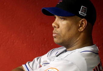 PHOENIX - AUGUST 11:  Starting pitcher Livan Hernandez #61 of the New York Mets reacts in the dugout after being removed from the major league baseball game against the Arizona Diamondbacks at Chase Field on August 11, 2009 in Phoenix, Arizona.  (Photo by Christian Petersen/Getty Images)