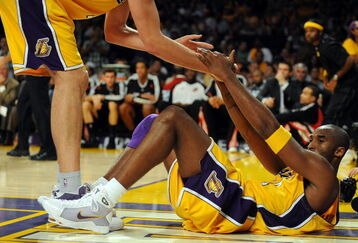LOS ANGELES, CA - OCTOBER 28:  Kobe Bryant #24 of the Los Angeles Lakers is helped up by teammate Pau Gasol #16 in the third quarter against the Portland Trail Blazers on October 28, 2008 at Staples Center in Los Angeles, California. NOTE TO USER: User expressly acknowledges and agrees that, by downloading and/or using this Photograph, user is consenting to the terms and conditions of the Getty Images License Agreement.  (Photo by Harry How/Getty Images)