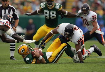 GREEN BAY, WI - SEPTEMBER 10:  Linebacker Lance Briggs #55 and defensive end Alex Brown #96 of the Chicago Bears gang tackle Brett Favre #4 of the Green Bay Packers during their game on September 10, 2006 at Lambeau Field in Green Bay, Wisconsin.  (Photo by Jonathan Daniel/Getty Images)