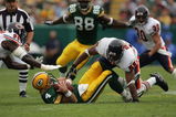 GREEN BAY, WI - SEPTEMBER 10:  Linebacker Lance Briggs #55 and defensive end Alex Brown #96 of the Chicago Bears gang tackle Brett Favre #4 of the Green Bay Packers during their game on September 10, 2006 at Lambeau Field in Green Bay, Wisconsin.  (Photo by Jonathan Daniel/Getty Images)