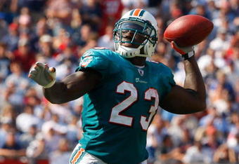 FOXBORO, MA - SEPTEMBER 21: Ronnie Brown #23 of he Miami Dolphins throws a touchdown pass in the third quarter against the New England Patriots at Gillette Stadium on September 21, 2008 in Foxboro, Massachusetts. (Photo by Jim Rogash/Getty Images)
