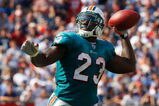 FOXBORO, MA - SEPTEMBER 21: Ronnie Brown #23 of he Miami Dolphins throws a touchdown pass in the third quarter against the New England Patriots at Gillette Stadium on September 21, 2008 in Foxboro, Massachusetts. (Photo by Jim Rogash/Getty Images)