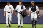 NEW YORK - JULY 01:  Pitcher Andy Pettitte #46 (C) of the New York Yankees walks in from the bullpen to start the game against the Seattle Mariners with teammate Jorge Posada #20 and pitching coach Dave Eiland on July 1, 2009 at Yankee Stadium in the Bronx borough of New York City.  (Photo by Jim McIsaac/Getty Images)