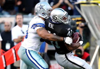 OAKLAND, CA - AUGUST 13:  Fullback Lorenzo Neal #41 of the Oakland Raiders is tackled by Anthony Spencer #93 of the Dallas Cowboys in the first quarter during the preseason game at Oakland-Alameda County Coliseum on August 13, 2009 in Oakland, California. (Photo by Jed Jacobsohn/Getty Images)