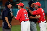 ATHENS - AUGUST 25:  Umpire Willie Rodriguez #3, R,  holds back coach Carlos Cepero #22, R, of Cuba as manager Higinio Velez #39 argues a call with home plate umpire Don Gilbert #15, L, against Australia in the gold medal baseball game on August 25, 2004 during the Athens 2004 Summer Olympic Games at the Baseball Centre in the Helliniko Olympic Complex in Athens, Greece.Cepero and Velez were arguing after Gilbert threw Cepero out of the game. (Photo by Donald Miralle/Getty Images)