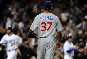 LOS ANGELES - AUGUST 20: Angel Guzman #37 of the Chicago Cubs reacts after giving up a grand slam home run in the sixth inning to Russell Martin #55 of the Los Angeles Dodgers (not shown) during the game at Dodger Stadium on August 20, 2009 in Los Angeles, California. (Photo by Harry How/Getty Images)