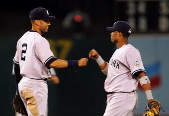 OAKLAND, CA - AUGUST 18:  Derek Jeter #2 and Robinson Cano #24 of the New York Yankees celebrate after they beat the Oakland Athletics at the Oakland Colisuem on August 18, 2009 in Oakland, California.  (Photo by Ezra Shaw/Getty Images)
