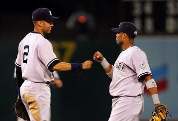 OAKLAND, CA - AUGUST 18:  Derek Jeter #2 and Robinson Cano #24 of the New York Yankees celebrate after they beat the Oakland Athletics at the Oakland Colisuem on August 18, 2009 in Oakland, California.  (Photo by Ezra Shaw/Getty Images)
