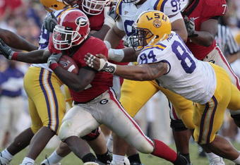 BATON ROUGE, LA - OCTOBER 25:  Knowshon Moreno #24 of Georgia outruns the tackle of Rahim Alem #84 in the second half of their football game at Tiger Stadium on October 25, 2008 in Baton Rouge, Louisiana.  Georgia won 52-38. (Photo by Dave Martin/Getty Images)
