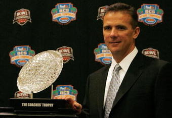 FORT LAUDERDALE, FL - JANUARY 07:  Head coach Urban Meyer of the Florida Gators poses with the 'The Coaches' Trophy' during the FedEx BCS Head Coaches Press Conference at Harbor Beach Marriott Resort & Spa on January 7, 2009 in Fort Lauderdale, Florida.  (Photo by Doug Benc/Getty Images)