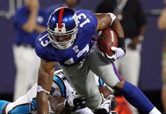 EAST RUTHERFORD, NJ - AUGUST 17:  Ramses Barden #13 of the New York Giants runs the ball past the tackle attempt from Mortty Ivy #54 of the Carolina Panthers on August 17, 2009 at Giants Stadium in East Rutherford, New Jersey. The Giants defeated the Panthers 24-17.  (Photo by Jim McIsaac/Getty Images)