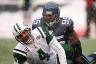 SEATTLE - DECEMBER 21:  Quarterback Brett Favre #4 of the New York Jets looks up after being tackled by Lawrence Jackson #95 of the Seattle Seahawks on December 21, 2008 at Qwest Field in Seattle, Washington. The Seahawks defeated the Jets 13-3. (Photo by Otto Greule Jr/Getty Images)