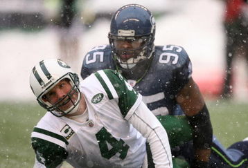SEATTLE - DECEMBER 21:  Quarterback Brett Favre #4 of the New York Jets looks up after being tackled by Lawrence Jackson #95 of the Seattle Seahawks on December 21, 2008 at Qwest Field in Seattle, Washington. The Seahawks defeated the Jets 13-3. (Photo by Otto Greule Jr/Getty Images)