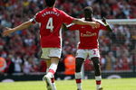 LONDON - APRIL 26:  Cesc Fabregas of Arsenal celebrates with his team mate Emmanuel Eboue after Fabregas scored the second goal during the Barclays Premier League match between Arsenal and Middlesbrough at Emirates Stadium on April 26, 2009 in London, England.  (Photo by Hamish Blair/Getty Images)