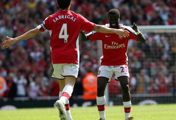LONDON - APRIL 26:  Cesc Fabregas of Arsenal celebrates with his team mate Emmanuel Eboue after Fabregas scored the second goal during the Barclays Premier League match between Arsenal and Middlesbrough at Emirates Stadium on April 26, 2009 in London, England.  (Photo by Hamish Blair/Getty Images)