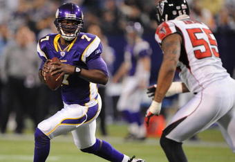 MINNEAPOLIS - DECEMBER 21:  Tarvaris Jackson #7  of the Minnesota Vikings scrambles under pressure from John Abraham #55 of the Atlanta Falcons during an NFL game at the Hubert H. Humphrey Metrodome, on December 21, 2008 in Minneapolis, Minnesota.  (Photo by Tom Dahlin/Getty Images)
